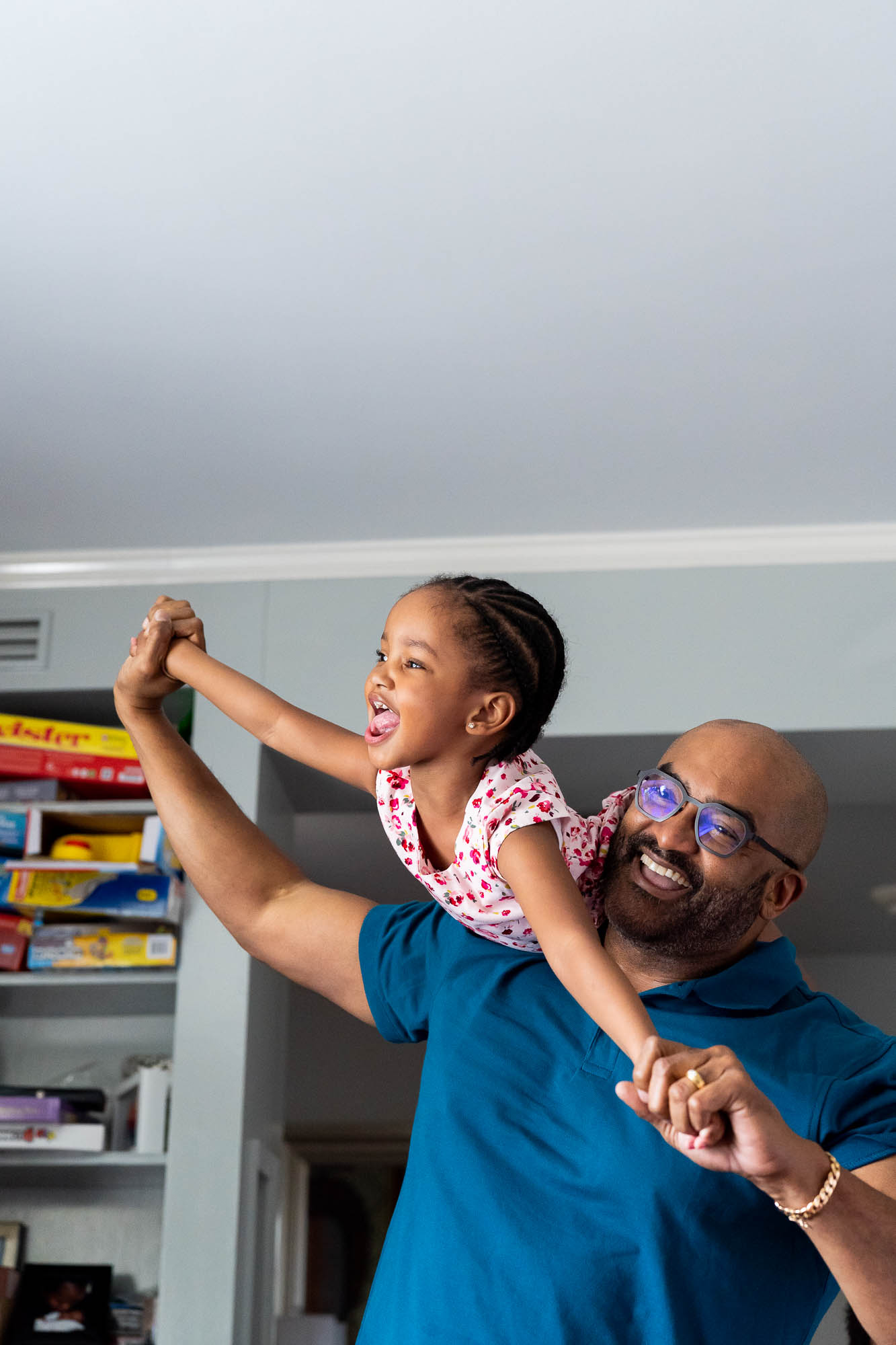 Dad playing airplane with daughter