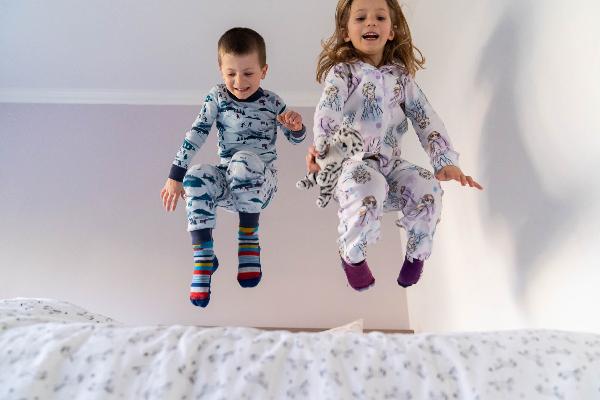 kids jumping on beds in pajamas