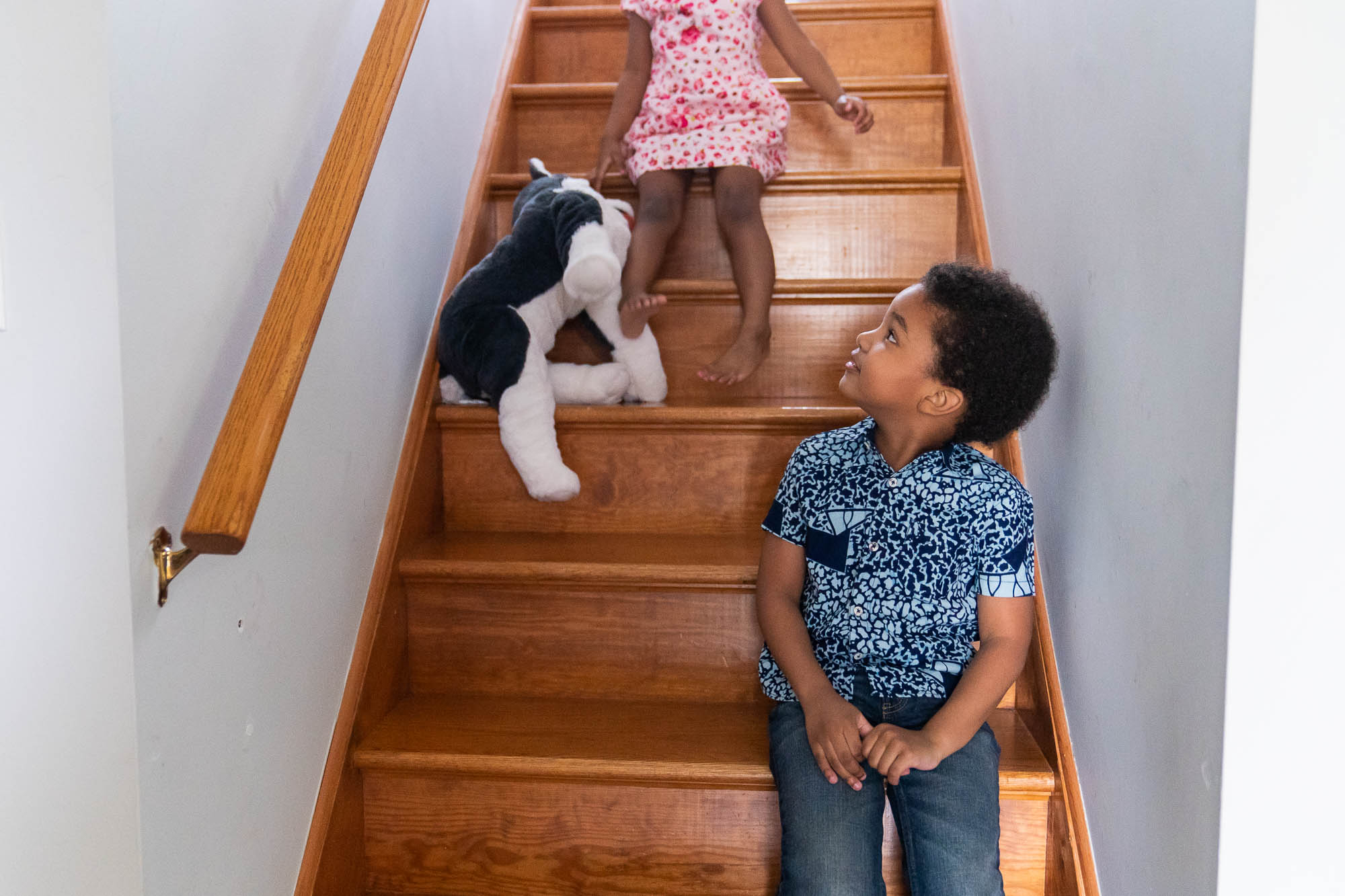 two kids sitting on stairs