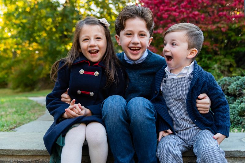 three kids posing for holiday card photo