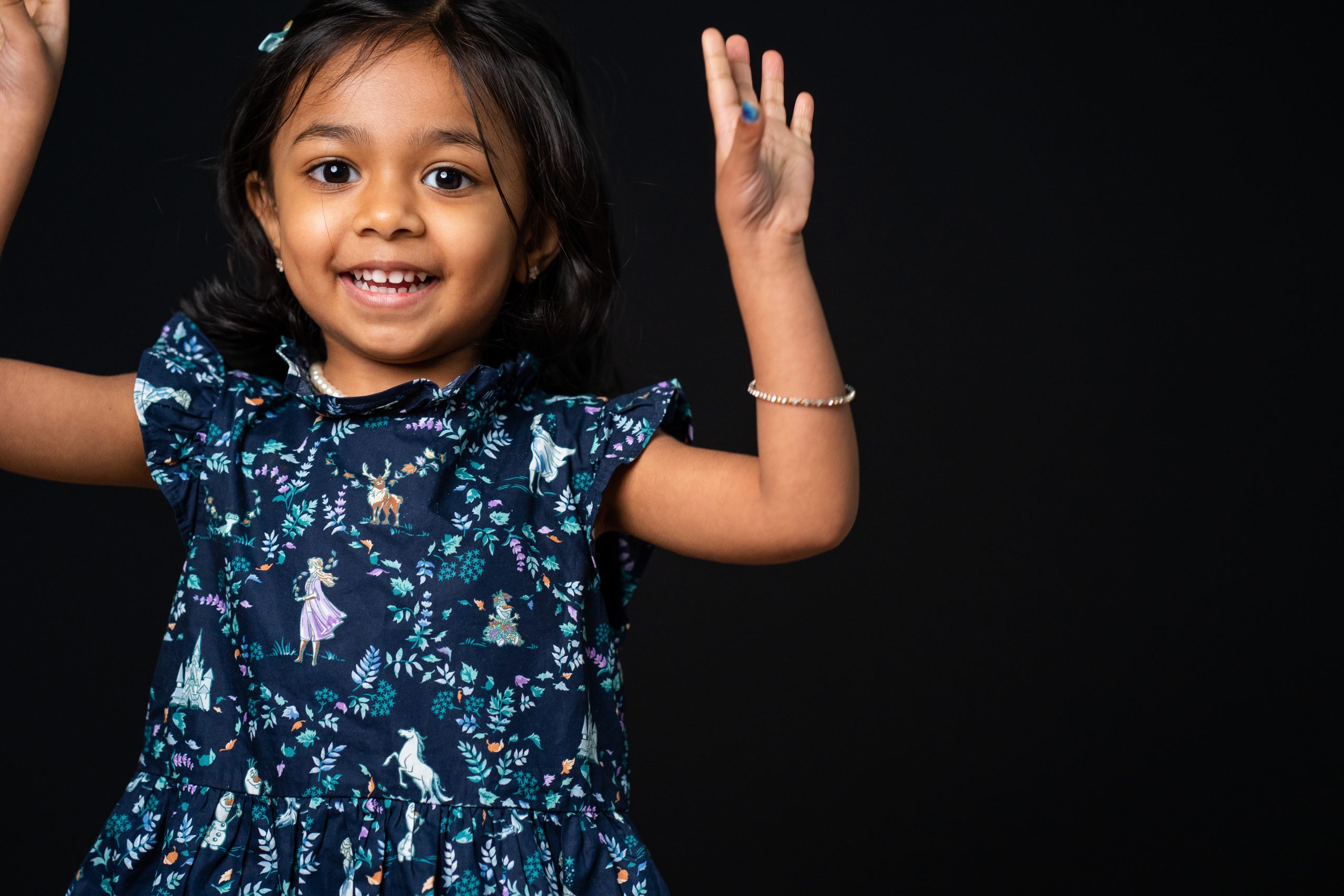 LITTLE GIRL jumping in a blue dress