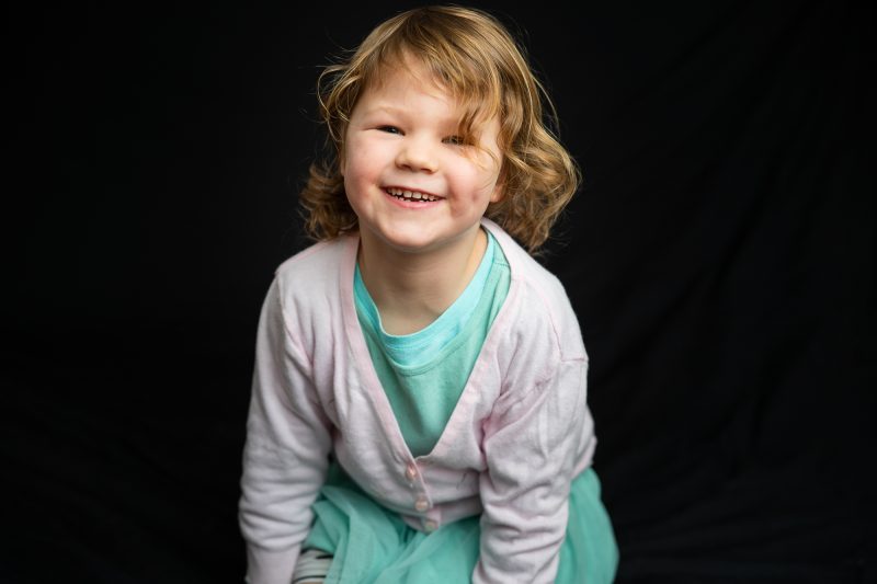 cute kid posing for a portrait at a kid portrait popup event in Westchester